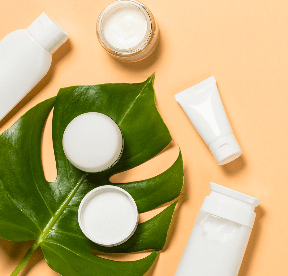 Skincare products on a green leaf background.