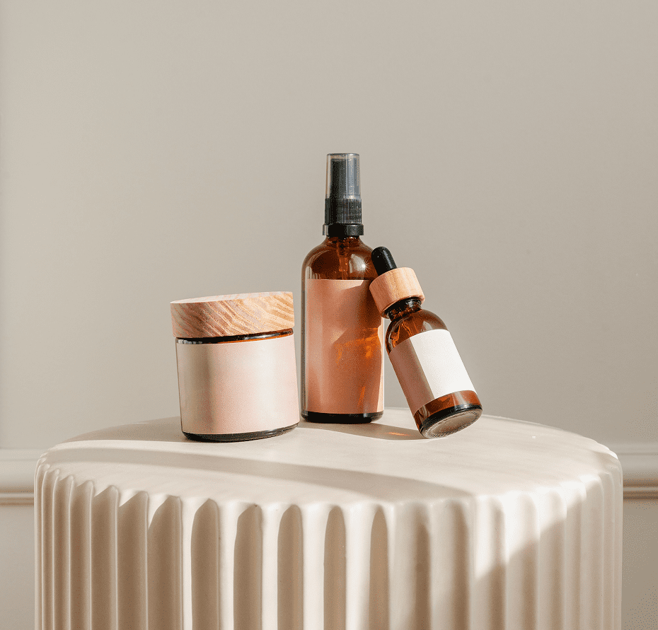 Cosmetic bottles on a textured surface.